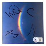 The Cold Play Band Signed Moon Music CD Insert from Sports Integrity features three bold signatures, a Beckett authentication sticker with QR code, and vivid moon and rainbow artwork on blue.