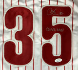 The Sports Integrity Cole Hamels Philadelphia Signed White Baseball Jersey features red pinstripes, a large red 35, and a silver autograph with "08 WS MVP." Authenticated by JSA.