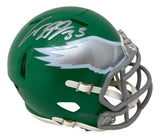 The Cooper DeJean Signed Philadelphia Eagles Kelly Green Mini Speed Helmet by Sports Integrity features a silver eagle wing logo, gray faceguard, and a large silver autograph on top.
