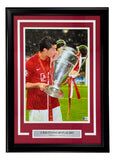 The Sports Integrity Cristiano Ronaldo Signed Framed 11x17 Manchester United Trophy Photo features Ronaldo kissing the UEFA Champions League trophy, his autograph, and a nameplate, with BAS LOA authentication.