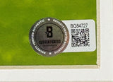 A Beckett authentication sticker with QR code and serial number BQ84727 is affixed to the Cristiano Ronaldo Signed Framed 11x17 Manchester United Trophy Photo by Sports Integrity.