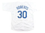 A Dave Roberts Los Angeles white baseball jersey by Sports Integrity is displayed flat, featuring blue "ROBERTS" text, number 30 on the back, and a small autograph above the number.