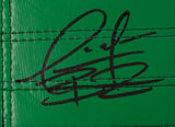 A close-up of Deontay Wilder's black autograph on a green textured, stitched surface of a Sports Integrity Full Size Replica Boxing Championship Belt.