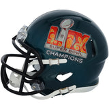 A dark green Devonta Smith Signed Eagles Super Bowl LIX Champions Mini Speed Helmet by Sports Integrity features a black facemask and celebratory logo in orange, white, and gray with a stylized football graphic.