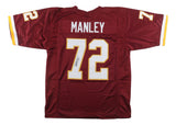 A Sports Integrity Dexter Manley Washington burgundy football jersey, featuring yellow and white accents, MANLEY and 72 on the back. The number 72 is autographed and JSA authenticated.