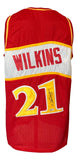 The Sports Integrity Dominique Wilkins Atlanta Signed Red Basketball Jersey BAS is red with yellow and white accents, featuring "WILKINS" and the number 21 on the back, which has a signature on it.