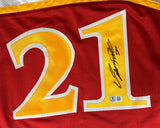 The Sports Integrity Dominique Wilkins Atlanta Signed Red Basketball Jersey BAS features the number 21 in large yellow and white digits, with “1” signed in black marker and a small authentication sticker below the signature.
