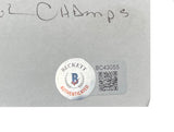 Close-up of a Beckett BC43055 authentication sticker with QR code and "Authenticated" in red on a Donny Anderson Signed Green Bay Packers Index Card SB Champs Inscribed, by Sports Integrity. Handwritten inscription visible above on gray paper.