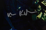 Val Kilmer's autograph in large, looping silver letters is displayed on a dark background of a framed 16x20 Top Gun movie photo by Sports Integrity; the signature is not clearly legible.