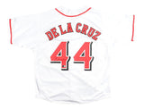 The Sports Integrity Elly De La Cruz Cincinnati Signed White Baseball Jersey BAS features red and black trim, with "DE LA CRUZ" and the number 44 in bold red lettering on the back.