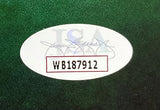 A white oval sticker with JSA faintly visible and WB187912 in bold black inside a red rectangle appears on the green textured 11x17 Entourage Movie Photo signed by Adrien Grenier & others, sold by Sports Integrity.