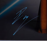 The Sports Integrity Ewan McGregor Signed Framed 16x20 Star Wars Obi-Wan Kenobi Collage Photo (JSA) features a blue signature on a dark background, with part of it overlapping a brown vertical object on the right and diagonal blue light at the top left.