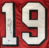 The Sports Integrity Hines Ward Georgia Signed Red Football Jersey features a large white number 19 outlined in black and is autographed in black marker on the left side of the number.