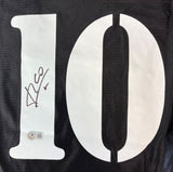 A close-up of the Luis Figo Signed Real Madrid Black Adidas Soccer Jersey by Sports Integrity, showing a large white number 10 with Figo’s black ink signature on the left and a BAS authenticity sticker below.