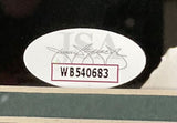 A close-up of a white oval JSA sticker with black text WB540683 and signatures, attached to the Sports Integrity Brandon Graham Signed Framed 16x20 Eagles SB52 Spotlight Strip Sack Photo.
