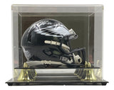 The Sports Integrity Jason Kelce Signed Philadelphia Eagles Black Mini Speed Helmet, featuring a PSA Holo, is displayed in a clear case with gold and black accents.