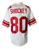 A Sports Integrity Jeremy Shockey New York white football jersey features red stripes, "SHOCKEY" and #80 in red on the back, and is signed by Shockey inside the "0".