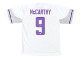 Back of a Sports Integrity JJ McCarthy Minnesota Signed White Football Jersey, featuring silver and purple trim, "McCARTHY" name, large purple #9 with autograph. BAS authenticated.
