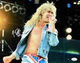 Joe Elliott, Def Leppard's blonde-haired singer, energetically performs on stage in this 11x14 photo signed and authenticated by JSA ITP. Offered by Sports Integrity. Stage lights and equipment appear in the background.