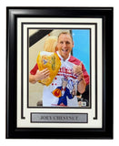 The Sports Integrity Joey Chestnut Signed Framed 8x10 "Jaws" Photo features the eating legend with a Nathan’s hot dog, wearing a bib and giving a thumbs up. Includes signature and nameplate—perfect for collectors.