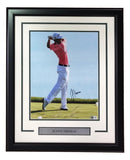 Sports Integrity’s Justin Thomas Signed Framed 11x14 PGA Golf Photo (BAS) features a golfer mid-swing in red shirt and white pants, with his signature and a plaque reading JUSTIN THOMAS.