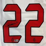 A white Kaka-signed AC Milan 2007 Champions League Adidas soccer jersey by Sports Integrity, with large red number 22, Kaka’s autograph on the left 2, and AC Milan's logo with a star below each number.