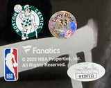 Close-up of logos and authentication stickers on the Larry Bird Signed In White Framed 16x20 Celtics Photo w/ Auerbach Bird+JSA by Sports Integrity, featuring team logos, copyright, and holographic authentication labels.