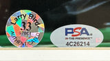 Close-up of authentication stickers for the Sports Integrity Larry Bird Signed Framed 16x20 Celtics vs Michael Jordan Photo Bird+PSA/DNA, featuring a holographic Larry Bird 33 sticker #97864 and oval PSA IN-THE-PRESENCE #4C26214.