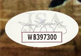 A white oval sticker with serial number WB397300 in black text and faint signatures/JSA in the background is on the Sports Integrity Larry Bird Signed Framed 8x10 Boston Celtics vs Lakers Photo.