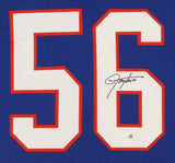 The Sports Integrity Lawrence Taylor New York Signed Framed Blue Football Jersey features a large white number 56 outlined in red, autographed in black marker, and authenticated with a JSA QR hologram.