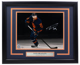 The Sports Integrity Leon Draisaitl Signed Framed Edmonton Oilers 11x14 Spotlight Photo by Fanatics features his autograph and a nameplate beneath, perfect for any hockey fan's collection.