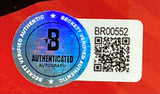 A Beckett Authenticated Martin Truex Jr Signed Framed 8x10 NASCAR Photo by Sports Integrity features a blue holographic seal, the letter B, serial number BR00552 with QR code on a red background.