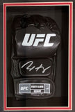 A Max Holloway signed UFC replica fight glove by Sports Integrity is showcased in a shadowbox with red and white border; the glove is black with a white autograph and labeled UFC FIGHT GLOVE SEIGHT L.