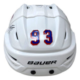 A Mika Zibanejad signed New York Rangers full size authentic Bauer helmet by Sports Integrity, white with the number 93 in red and blue on the back and a black autograph on the left side.