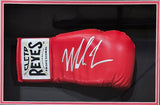A Mike Tyson signed red right-hand Cleto Reyes boxing glove from Sports Integrity is displayed in a shadowbox, featuring a bold white autograph across the top.