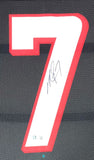The Sports Integrity Michael Vick Atlanta Signed Framed Black Football Jersey BAS ITP features a large white number 7 with a red border on a black mesh background, signed in black ink across the middle.