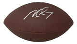 A brown NFL Wilson Super Grip football signed by Michael Vick of the Atlanta Falcons is shown against a white background. Brand: Sports Integrity.