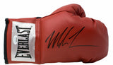 A Mike Tyson signed red Everlast right hand boxing glove by Sports Integrity, featuring a bold autograph on the top.