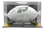 A white Nakobe Dean signed Eagles logo football by Sports Integrity is displayed in a clear Super Bowl 59 case, featuring etched Eagles logos and authentication by PSA/DNA.