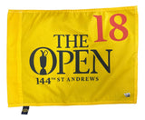 The Sports Integrity 144th Open Championship At St. Andrews PGA Event Issued Golf Pin Flag features a yellow design with "18" in red and "THE OPEN 144TH ST ANDREWS" in black, plus a trophy silhouette, representing the famed tournament.