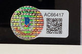 A holographic authentication sticker with a checkmark is next to a white label displaying "AC66417" and a QR code on the Sports Integrity Ted Williams Bobby Orr Larry Bird Signed Framed 16x20 Boston Legends Photo BAS.