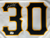 A close-up of the Paul Skenes Signed Pittsburgh Pirates White Nike Replica Jersey by Sports Integrity, featuring a bold number 30 with a silver autograph above the 3 and MLB authentication stickers below.