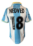 The Sports Integrity Pavel Nedved Signed Lazio Puma Soccer Jersey BAS features light blue and white stripes, NEDVED and number 18 on the back with a signature on the number 1, Puma logos on the sleeves, and a yellow-blue collar.