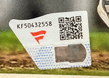 A white security sticker with code KF50432558, a red/white logo, QR code, and silver holographic seal appears on the Pete Crow-Armstrong Signed Framed 8x10 Chicago Cubs Photo Fanatics by Sports Integrity against a blurred green/brown background.