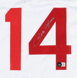 The Sports Integrity Pete Rose Cincinnati Signed White Baseball Jersey BAS features a large red number 14, with Pete Rose’s silver signature on the number 4 and a small black and white circular sticker near its bottom.