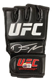 The Dustin Poirier Signed UFC Fight Glove by Sports Integrity is a black, fingerless glove with a white UFC logo, silver autograph on the back, and a red and gold detailed UFC patch near the wrist strap.