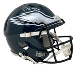 The Sports Integrity Quinyon Mitchell Signed Philadelphia Eagles Full Size Speed Replica Helmet features a dark green shell, white eagle wing design, black faceguard, and a white autograph on top. Authenticated by JSA.