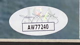 A white oval sticker with “AW77240” in bold black, a printed signature, the “JSA” watermark, and a subtle colorful design is featured on the Sports Integrity Randy Quaid Signed Framed 16x20 Christmas Vacation Photo.