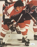 Reggie Leach crouches for a faceoff in this autographed 8x10 Philadelphia Flyers photo (#27), authenticated by JSA (AL44173). Available from Sports Integrity.