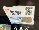 A close-up of a Fanatics authentication sticker (code DQ16494881, QR code, hologram) is seen on the Sports Integrity Rhea Ripley Signed Framed 8x10 WWE Photo, with the partial WWE logo below.